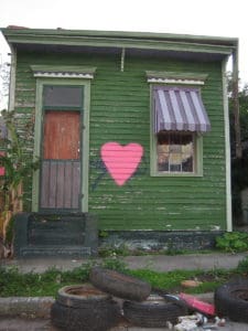 Small "shotgun" style house in the Bayou St. John neighbourhood has a heart painted over the mark of the post-storm search & rescue team (Photo Credit: Infrogmation). 